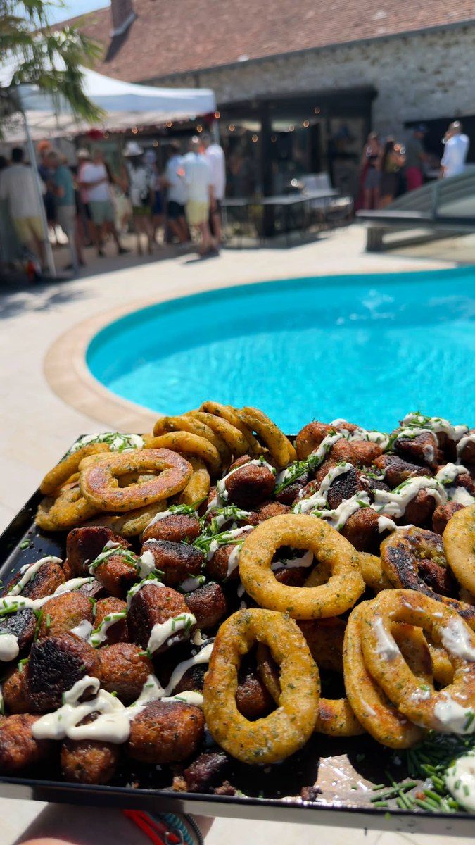Plateau de calamars et de saucisses nappés de sauce, piscine au fond